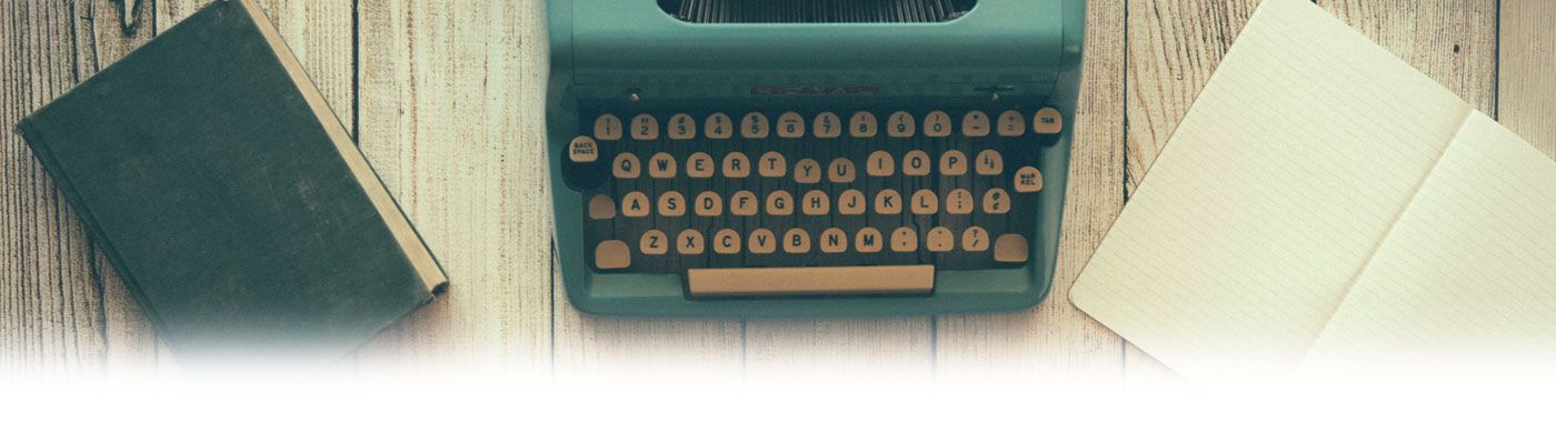 A vintage typewriter and notebooks on a desk